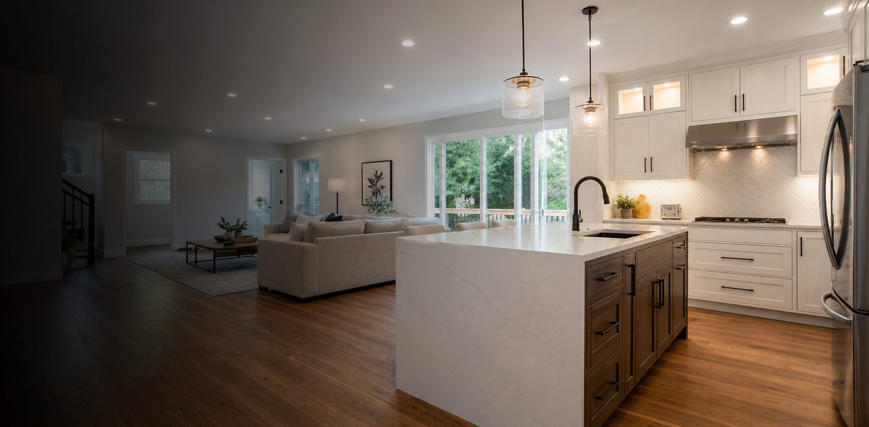 Freshly remodeled home interior with modern kitchen, wood flooring, and warm lighting